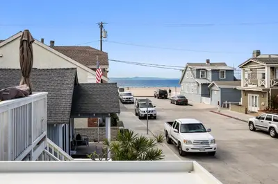 a view of a street with cars parked on the beach at Charming Oceanview 3Br Half Block To 29Th St Beach By Beachview Rentals in Newport Beach