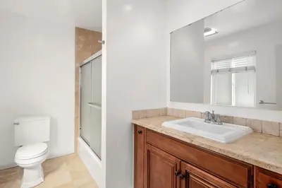 a bathroom with a sink and a toilet and a mirror at Charming Oceanview 3Br Half Block To 29Th St Beach By Beachview Rentals in Newport Beach