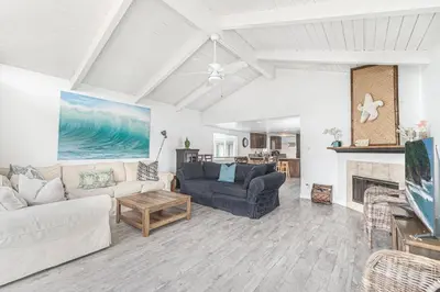 a living room with a couch and a fireplace at Charming Oceanview 3Br Half Block To 29Th St Beach By Beachview Rentals in Newport Beach
