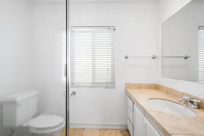 a bathroom with a toilet and a sink and a shower at Charming Oceanview 3Br Half Block To 29Th St Beach By Beachview Rentals in Newport Beach