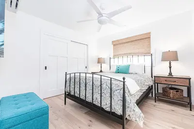 a bedroom with a bed and a ceiling fan at Luxury 4Br Coastal Retreat W Rooftop Deck And Ocean Views By Beachview Rentals in Newport Beach
