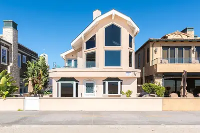 a house on the side of a street at Oceanfront 2Br W Ac, Updated Interior, And Panoramic Views By Beachview Rentals in Newport Beach