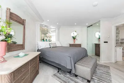 a bedroom with a bed and a mirror at Oceanfront 2Br W Ac, Updated Interior, And Panoramic Views By Beachview Rentals in Newport Beach