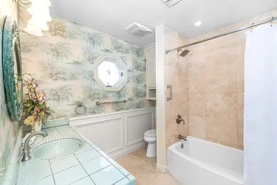 a bathroom with a tub and a shower and a toilet at Oceanfront 2Br W Ac, Updated Interior, And Panoramic Views By Beachview Rentals in Newport Beach