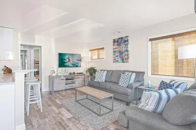 a living room with a couch and a table at Cozy 2Br Cottage W Ac, Prime Location One House From Sand By Beachview Rentals in Newport Beach