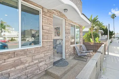 a patio with two chairs and a bench on a house at Cozy 2Br Cottage W Ac, Prime Location One House From Sand By Beachview Rentals in Newport Beach