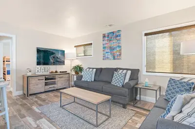 a living room with a couch and a table at Cozy 2Br Cottage W Ac, Prime Location One House From Sand By Beachview Rentals in Newport Beach