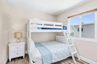 a bedroom with two bunk beds and a window at Stylish 2Br Upstairs Cottage W Ac One House From Beach By Beachview Rentals in Newport Beach