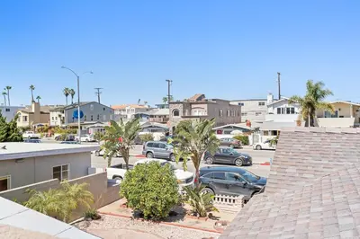 a city with cars parked in a parking lot at Stylish 2Br Upstairs Cottage W Ac One House From Beach By Beachview Rentals in Newport Beach