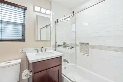 a bathroom with a toilet and a sink and a shower at Stylish 2Br Upstairs Cottage W Ac One House From Beach By Beachview Rentals in Newport Beach