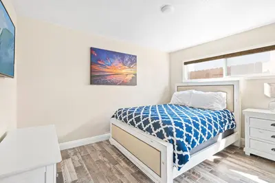 a bedroom with a bed and a window at Cozy Cottage W Ac, Stylish Interior, One House From Beach By Beachview Rentals in Newport Beach