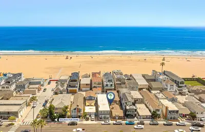 an aerial view of a beach with houses and cars at Cozy Cottage W Ac, Stylish Interior, One House From Beach By Beachview Rentals in Newport Beach