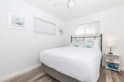 a white bedroom with a bed and two windows at Pet-Friendly 3Br W Sun Deck, And Bbq, One Block To Beach By Beachview Rentals in Newport Beach