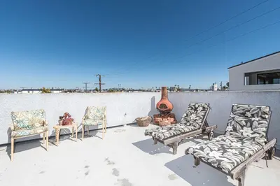 a group of chairs sitting on a patio at Pet-Friendly 3Br W Sun Deck, And Bbq, One Block To Beach By Beachview Rentals in Newport Beach