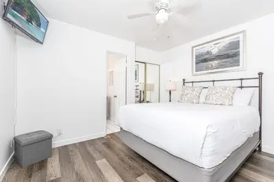 a white bedroom with a bed and a ceiling fan at Pet-Friendly 3Br W Sun Deck, And Bbq, One Block To Beach By Beachview Rentals in Newport Beach