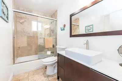 a bathroom with a sink and a toilet and a shower at 4Br Oceanfront W Ac, Panoramic Views In Coveted Location By Beachview Rentals in Newport Beach