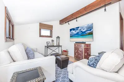 a living room with two white couches and a tv at Luxury 5Br Vacation Home W Rooftop Deck, Ocean Views, Ac By Beachview Rentals in Newport Beach