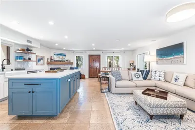 a kitchen and living room with a blue island at Luxury 5Br Vacation Home W Rooftop Deck, Ocean Views, Ac By Beachview Rentals in Newport Beach