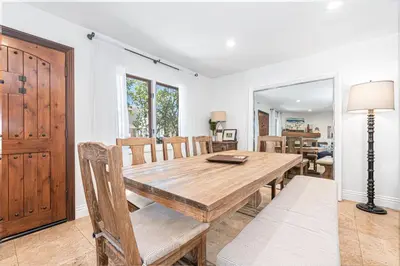 a dining room with a wooden table and chairs at Luxury 5Br Vacation Home W Rooftop Deck, Ocean Views, Ac By Beachview Rentals in Newport Beach