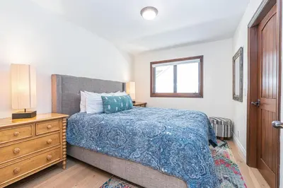 a bedroom with a bed and a dresser and a window at Luxury 5Br Vacation Home W Rooftop Deck, Ocean Views, Ac By Beachview Rentals in Newport Beach