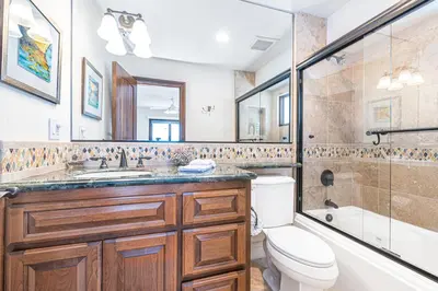 a bathroom with a sink and a toilet and a tub at Luxury 5Br Vacation Home W Rooftop Deck, Ocean Views, Ac By Beachview Rentals in Newport Beach