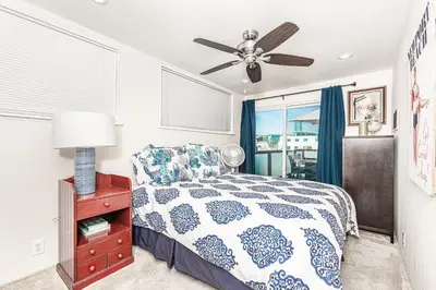 a bedroom with a bed and a ceiling fan at Cozy 2Br W Large Deck, Steps From Marina Park And Beach By Beachview Rentals in Newport Beach