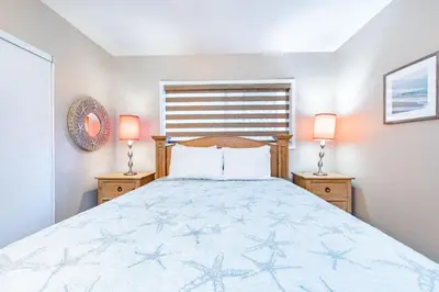 a bedroom with a bed with two night stands at 3Br Oceanfront In Desirable Location At Excellent Value By Beachview Rentals in Newport Beach