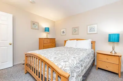 a bedroom with a bed and two night stands at 3Br Oceanfront In Desirable Location At Excellent Value By Beachview Rentals in Newport Beach