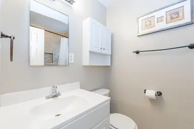 a white bathroom with a sink and a toilet at 3Br Oceanfront In Desirable Location At Excellent Value By Beachview Rentals in Newport Beach