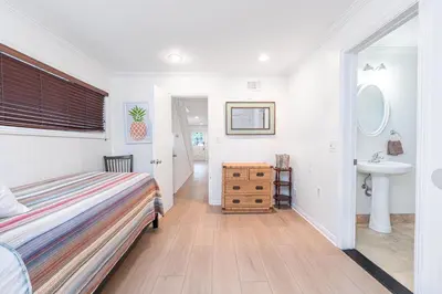 a bedroom with a bed and a sink at Quiet 4Br Home W Large Deck And Bbq, 2 Blocks From Sand By Beachview Rentals in Newport Beach