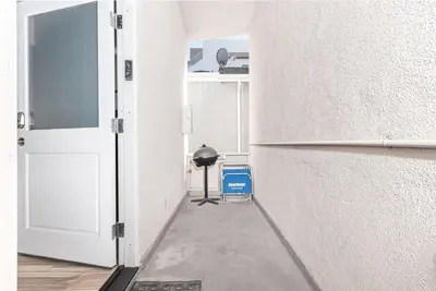 an empty hallway with an open door and a trash can at Cozy 2Br Upstairs Cottage Steps From Sand In Prime Location By Beachview Rentals in Newport Beach