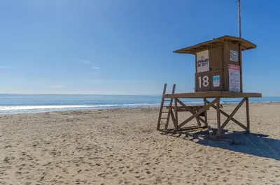 a lifeguard stand on a beach with the ocean at 3Br Beach Cottage W Large Patio And Grill, Prime Location By Beachview Rentals in Newport Beach