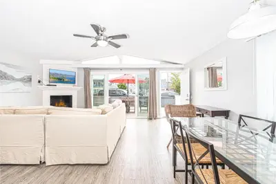 a living room with a couch and a table at 3Br Beach Cottage W Large Patio And Grill, Prime Location By Beachview Rentals in Newport Beach