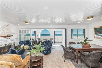 a living room with a table and chairs at Spectacular 6Br Oceanfront Home In Highly-Coveted Location By Beachview Rentals in Newport Beach