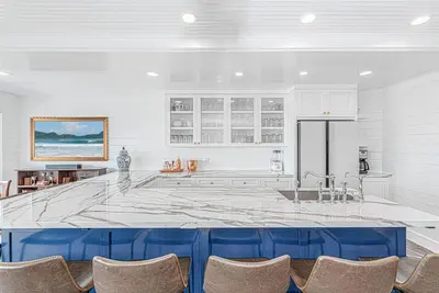 a large kitchen with a large marble counter top at Spectacular 6Br Oceanfront Home In Highly-Coveted Location By Beachview Rentals in Newport Beach