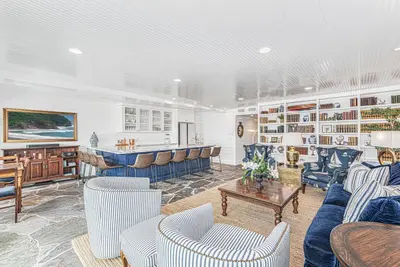 a living room with couches and a bar at Spectacular 6Br Oceanfront Home In Highly-Coveted Location By Beachview Rentals in Newport Beach