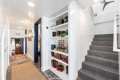 a staircase in a home with white walls and a stair case at Spectacular 6Br Oceanfront Home In Highly-Coveted Location By Beachview Rentals in Newport Beach