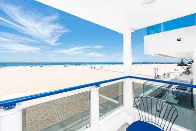 a balcony with a view of the beach at Luxe Oceanfront 3Br W Rooftop Deck, Pier To Pier Location By Beachview Rentals in Newport Beach