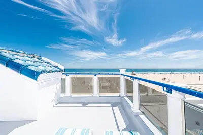 a view of the beach from the balcony of a beach house at Luxe Oceanfront 3Br W Rooftop Deck, Pier To Pier Location By Beachview Rentals in Newport Beach