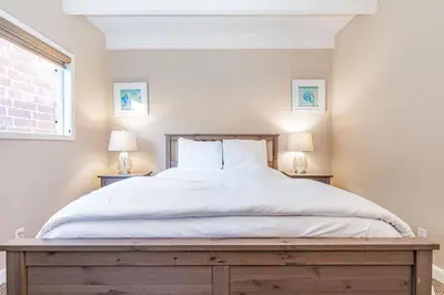 a bedroom with a large white bed with two lamps at 3Br Oceanfront In Desirable Location At Excellent Value By Beachview Rentals in Newport Beach