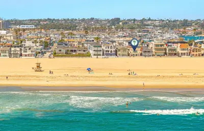 a view of a beach with a city in the background at 3Br Oceanfront In Desirable Location At Excellent Value By Beachview Rentals in Newport Beach