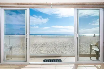 a view of the beach from a window at 3Br Oceanfront In Desirable Location At Excellent Value By Beachview Rentals in Newport Beach