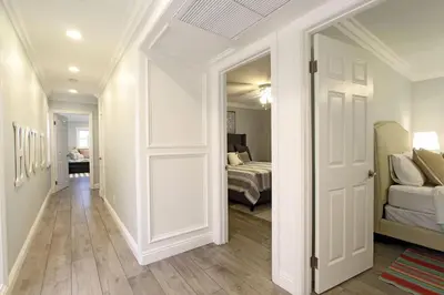 a hallway with a door leading to a bedroom at Stylish 3Br Oceanfront W Gorgeous Views, Boardwalk Access By Beachview Rentals in Newport Beach