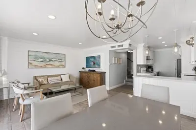 a dining room and living room with a table and chairs at Stylish 3Br Oceanfront W Gorgeous Views, Boardwalk Access By Beachview Rentals in Newport Beach