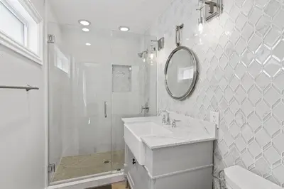 a white bathroom with a sink and a mirror at Stylish 3Br Oceanfront W Gorgeous Views, Boardwalk Access By Beachview Rentals in Newport Beach