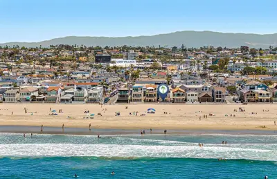 a view of a beach with people in the water at Stylish 3Br Oceanfront W Gorgeous Views, Boardwalk Access By Beachview Rentals in Newport Beach
