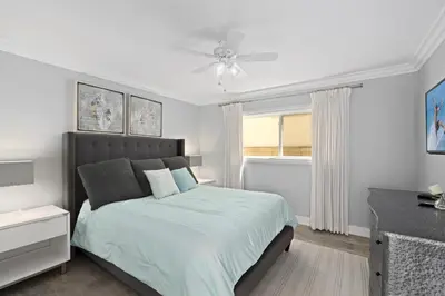 a bedroom with a bed and a ceiling fan at Stylish 3Br Oceanfront W Gorgeous Views, Boardwalk Access By Beachview Rentals in Newport Beach