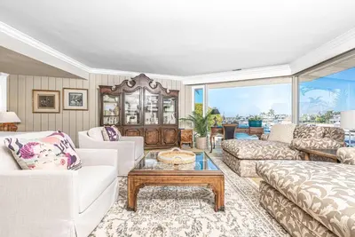 a living room with a couch and a table at Iconic 4Br Bayfront Home W Unmatched Indooroutdoor Living By Beachview Rentals in Newport Beach