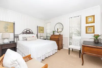 a bedroom with a bed and a desk and a piano at Iconic 4Br Bayfront Home W Unmatched Indooroutdoor Living By Beachview Rentals in Newport Beach