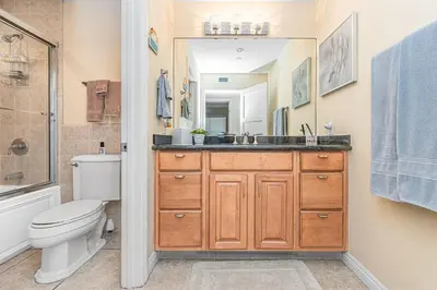 a bathroom with a sink and a toilet and a mirror at Affordable 2Br Oceanfront W Large Patio, Boardwalk Access By Beachview Rentals in Newport Beach